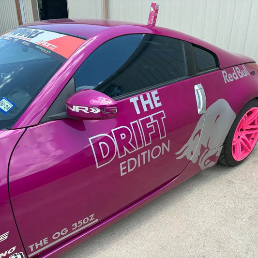 Pink car with 'Red Bull' and 'The Drift Edition' branding on a concrete surface.